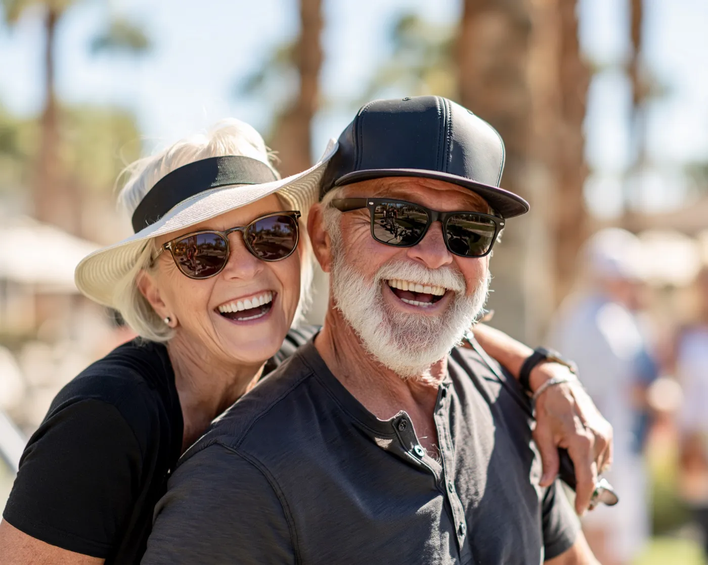 A smiling older couple outdoors on a sunny day